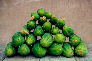 Pile of fresh organic cucumbers on a market