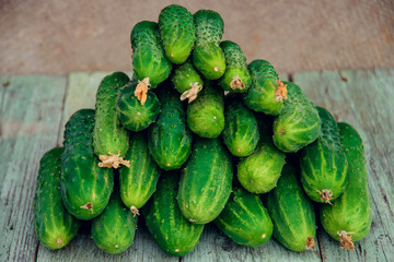 Pile of fresh organic cucumbers on a market