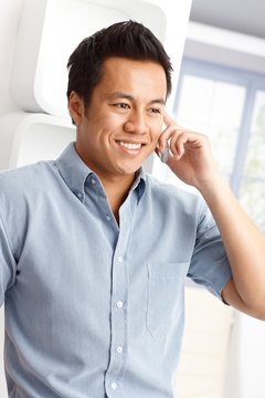 Portrait of Asian man on phone call