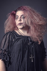 Crazy horror witch making scary faces, mad and deranged