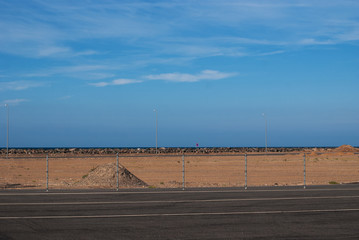 A mound of red sand on a blue sky background