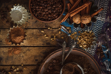 Roasted black and green coffee beans and ground coffee in the plate