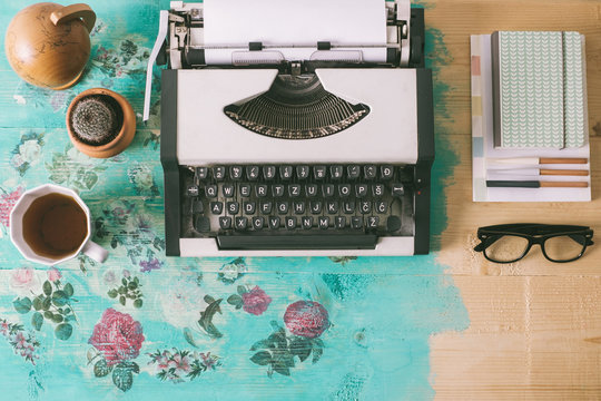 Typewriter and various items on the floral vintage table