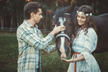 Fototapeta na wymiar Young couple and beautiful horse