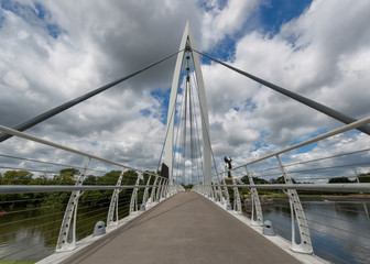 Pedestrian bridge over the Arkansas River by The Keeper of the Plains steel sculpture in Wichita, Kansas