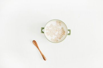 Cereal with milk on white background. Flat lay, top view.