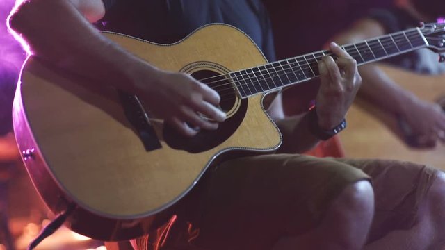 man playing guitar close up. Acoustic, classic, wooden guitar. Musician plays 