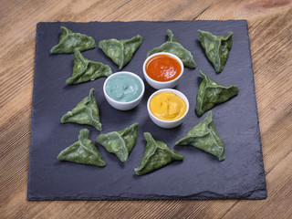Green dim sum, chinese food. Dumplings with beef meat or mashed potatoes or cottage cheese in the dough with spirulina