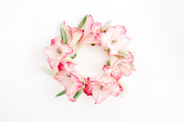 Beautiful pink gladiolus flower frame on white background. Flat lay, top view.