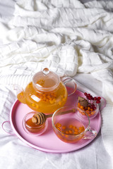 A cup of tea with sea buckthorn and herbs
