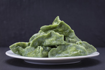 Green dim sum, chinese food. Dumplings with beef meat or mashed potatoes or cottage cheese in the dough with spirulina