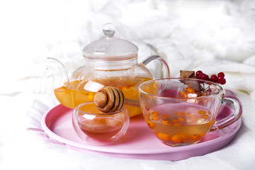 A cup of tea with sea buckthorn and herbs