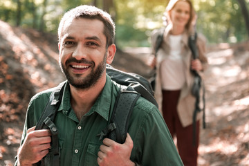 Fototapeta premium Happy married couple walking in the woods with enjoyment