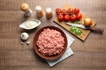 Composition with fresh raw minced meat on table