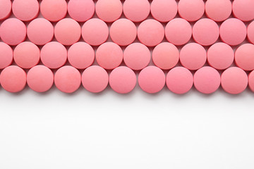 Color round pills on white background