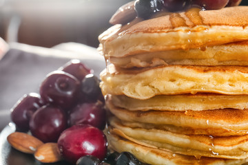 Plate with tasty pancakes and berries, closeup