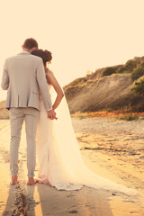 Happy wedding couple on beach