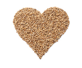 Heart made of hemp seeds on white background