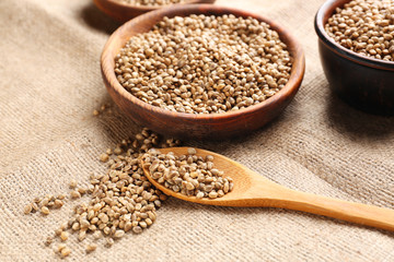 Bowl and spoon with hemp seeds on sackcloth