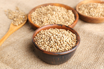Bowl with hemp seeds on sackcloth
