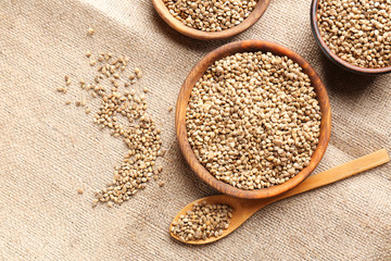 Bowls and spoon with hemp seeds on sackcloth