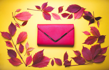 Red handbag on yellow autumn background