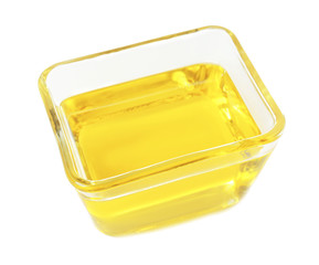 Glass bowl with cooking oil on white background