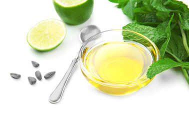 Composition with cooking oil and mint on white background