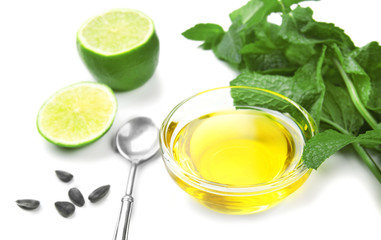 Composition with cooking oil and mint on white background