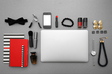 Comfortable workplace with modern laptop and female accessories on table