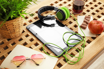 Comfortable blogger's workplace with modern tablet and headphones on table