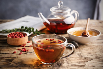 Composition with goji tea on wooden table