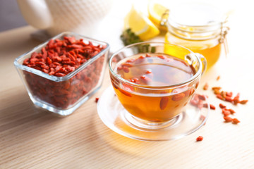Composition with goji tea on wooden table
