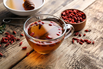 Composition with goji tea on wooden table