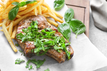 Delicious grilled steak frites on waxed paper