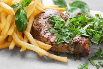 Delicious grilled steak frites on waxed paper