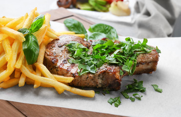 Delicious grilled steak frites on waxed paper