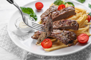 Fork with piece of delicious steak, closeup
