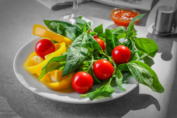 Plate with fresh vegetables on kitchen table