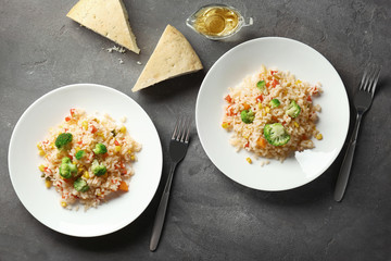 Plates with rice pilaf and broccoli on table