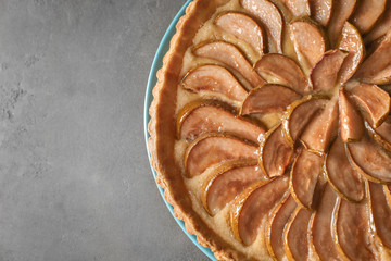 Plate with tasty pear tart on table