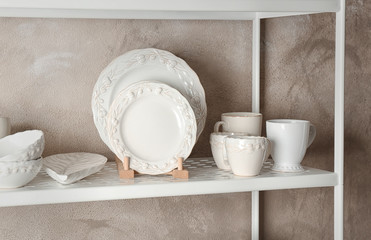 White tableware on storage stand indoors