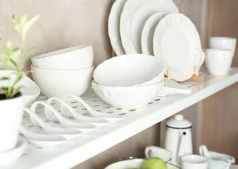 White tableware on storage stand indoors