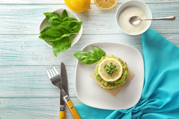 Plate with delicious broccoli pancakes on wooden background