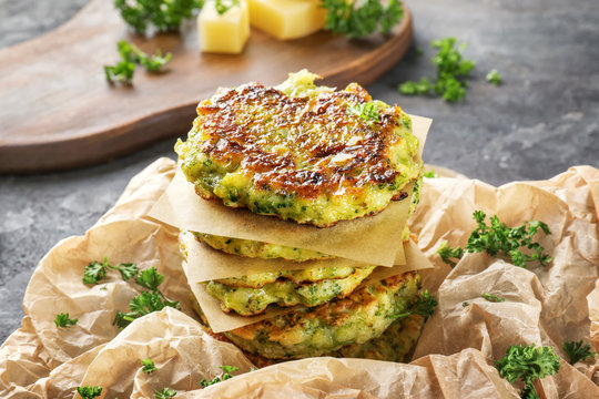 Delicious broccoli pancakes on table