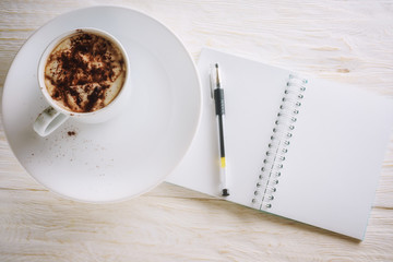 Sketchpad and cup of hot cocoa