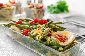 Bowl with yummy green bean casserole on kitchen table