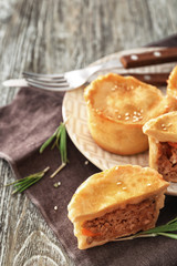 Delicious little meat pies on plate