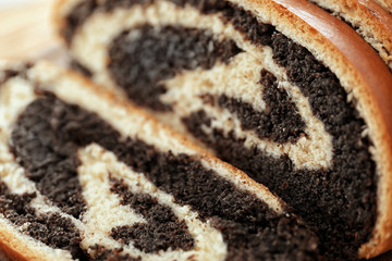 Tasty pastry with poppy seeds, close up