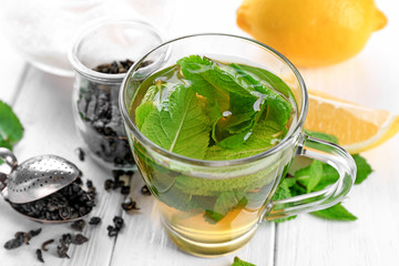 Cup of mint tea on wooden table